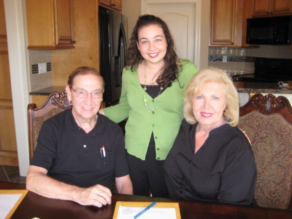 Jessica King with clients signing paperwork at a kitchen table